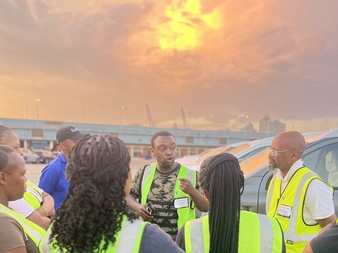 Pace Online team briefing stevedores at a South African port at sunset